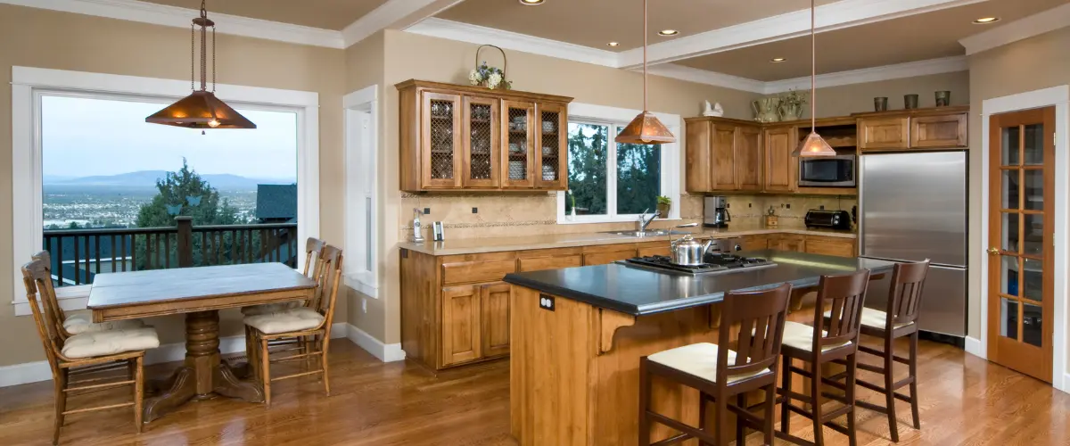 Rustic kitchen with wooden cabinetry and black countertops