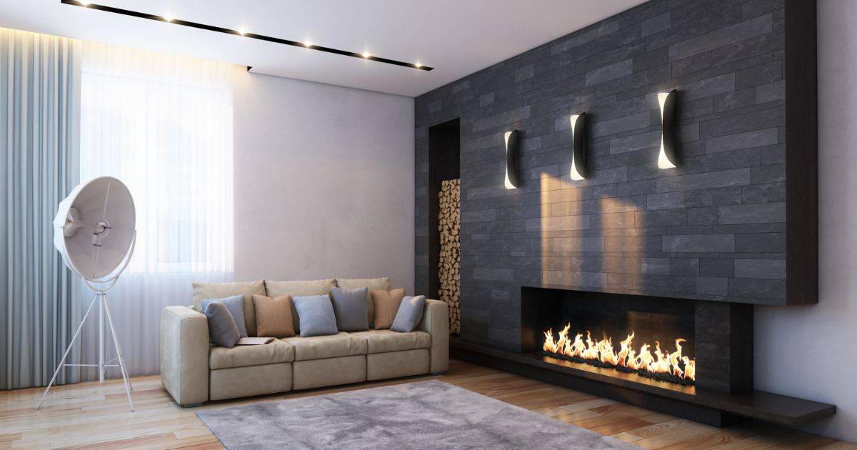 A warm rustic living room with exposed wooden beams, a stone fireplace, and leather furniture.