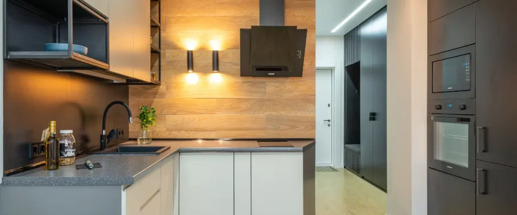 Modern kitchen with wood accent wall and under-cabinet lighting